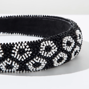 Close-up of handmade wide headband featuring black and white seed bead wave patterns