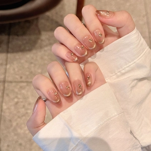 Mocha cat-eye press-on nails with french gradient and rhinestones in oval shape