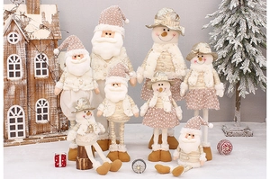 Close-up of golden and beige fabric Christmas plush figures with sparkling sequins