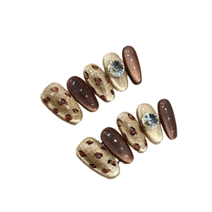 Handmade leopard cat eye press-on nails with gold glitter and crystal rhinestones