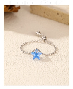 Detail view of adjustable S925 silver chain ring with blue star shaped pendant charm