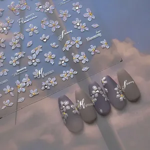 White pear blossom nail art stickers with crystal diamonds and elegant floral design