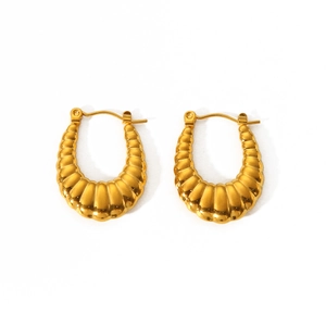 Détail de boucles d'oreilles créoles dorées en U avec texture nervurée et fermoir levier