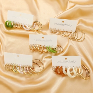 Elegant gold-tone twisted hoop earring set with vintage pearls and green resin charms
