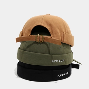 Detail of adjustable metal buckle and hip-hop embroidery on canvas docker hats