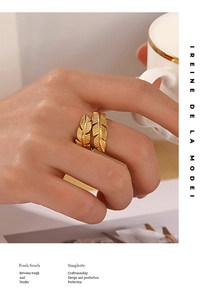 Detail of gold-plated feather open ring showing intricate leaf texture on model's hand