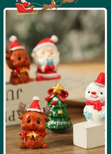 Close-up of assorted resin Christmas miniatures including Santa, reindeer, and snowman