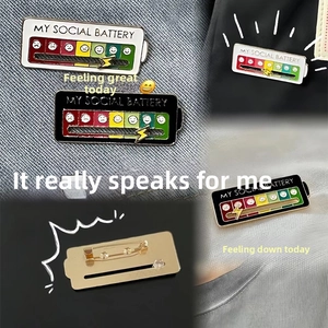 Macro view of my social battery enamel pins with sliding metal mood indicators