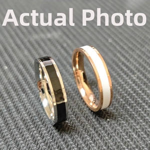 Detailed macro view of minimalist titanium steel enamel rings in silver and rose gold
