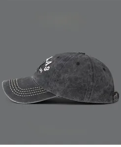 Detail of faded gray denim baseball cap showing 1841 embroidery and yellow stitching