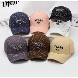 Close-up of quilted plaid baseball caps in seven colors with NY&JA 1987 embroidery