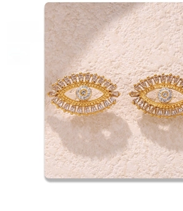 Close-up of gold Evil Eye stud earrings featuring micro-set zircon stones in a detailed view