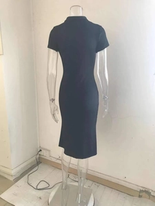 Detail of a black midi dress featuring short sleeves and a slim fit tailored back
