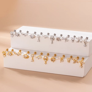 Minimalist stainless steel stud earrings set with zircon stones on white display stand