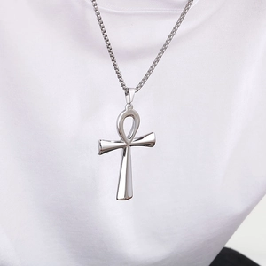 Polished silver Ankh cross necklace in stainless steel on a white T-shirt