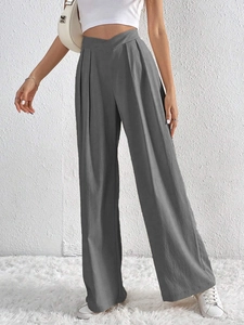 Detail showing the gray high-waisted wide-leg trousers with fine vertical texture