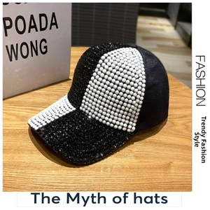 Close-up of baseball cap with white pearls on crown and black rhinestones on the brim