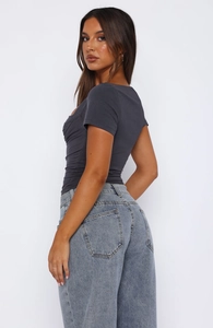 Detail of slim-fit dark grey short sleeve T-shirt with ruched design and blue jeans