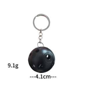 Black hollow golf ball keychain with 4.1cm diameter and metal ring on white background