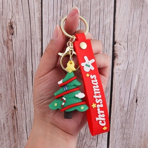 Detail of Christmas tree PVC keychain with red silicone strap and metal clasp ring
