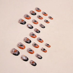 Oval Halloween press-on nails set featuring pumpkin, ghost, and black cat festive designs