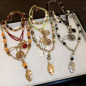 Three-layer bohemian beaded necklace with vintage coins and geometric metal pendants