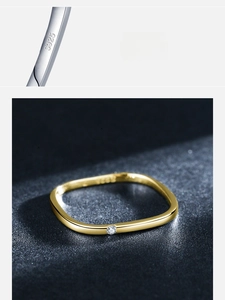 Macro detail of S925 hallmark on a minimalist gold-plated square ring with small diamond