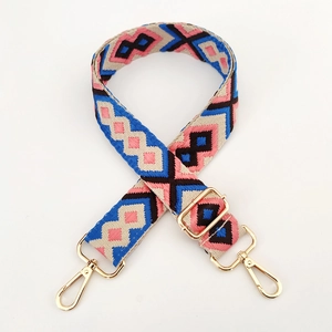 Close-up of colorful ethnic woven strap with golden metal hooks and adjustable buckle