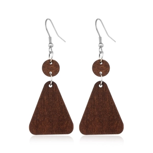 Detailed view of hollow geometric wooden drop earrings with polished dark wood texture