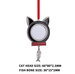 Cat-shaped metal Christmas ornament with red ribbon and small fish bone charm detail
