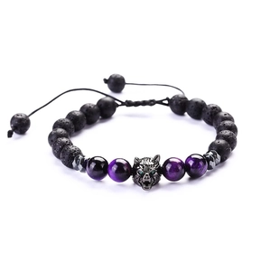 Detail of beaded wolf head bracelet with black lava stone and purple cat eye beads