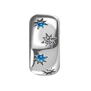 Detailed macro of silver rectangular charm with blue and clear star-shaped stones
