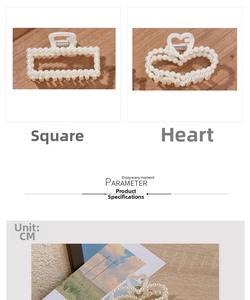 Detail view of pearl hair claws in square and heart shapes with metal spring and warm tones