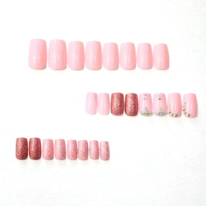 Pink press-on nails set with glitter and rhinestones in medium square shape