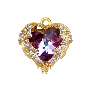 Macro detail of gold plated heart pendant with purple gemstone and pavé crystal wings