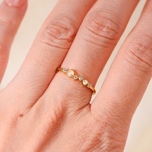 Macro detail of S925 silver gold-plated ring with opal and shimmering zircon stones