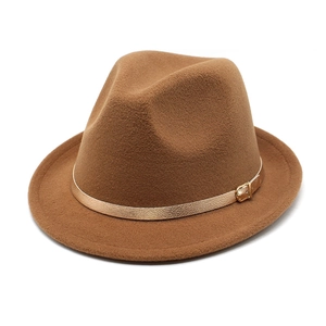 Detail of caramel wool fedora hat featuring a gold metallic buckle and decorative strap