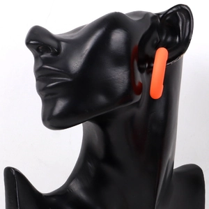 Fluorescent orange C-shaped chunky earrings with matte finish on a black mannequin