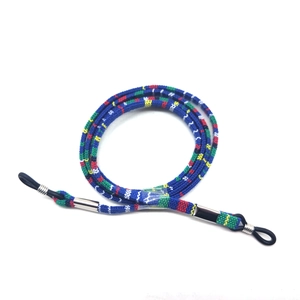 Close-up of ethnic style woven eyeglass strap with blue patterns and rubber loops
