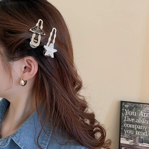 Y2K hair clip set featuring crystal star design and black enamel triangle clip
