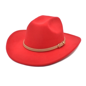 Detail of red wool fedora hat featuring a brown leather band and gold buckle