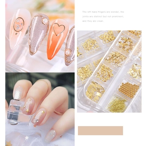 Golden nail art charms in a 12-grid box with hearts, stars and moons for manicure