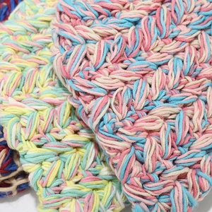 Detailed macro view of the thick hand-knitted textured yarn and mixed color weave