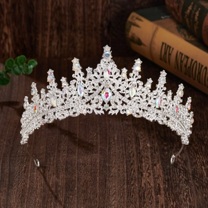 Macro view of crystal encrusted silver bridal tiara on dark wooden surface background