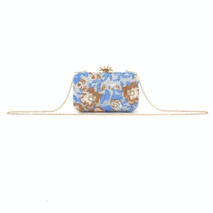 Detailed embroidery and golden metal frame with crown clasp on blue evening bag