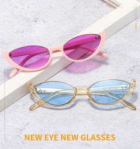 Detail view of stylish cat eye sunglasses in pink and champagne colors on stone background