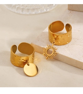 Detail of 18K gold plated hammered texture rings with sun and round charms on stone