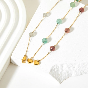 Y-shaped necklace with heart pendant and multicolor natural stones on a white stone base