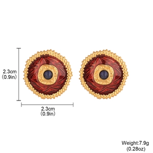 Vintage red enamel flower earrings with blue gems and gold edges on a white background