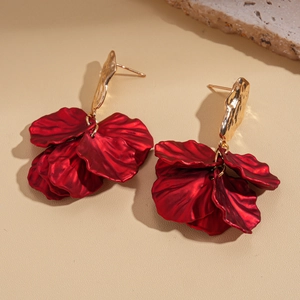 Detail view of retro red petal tassel earrings with golden accents and floral shape
